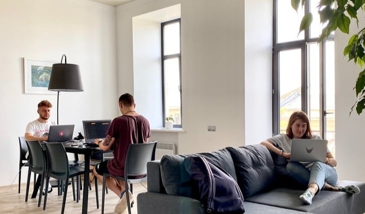 Three people in the light casual office set up