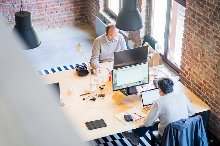 Two man working at their desks in the office