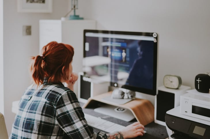 A woman working on her iMac