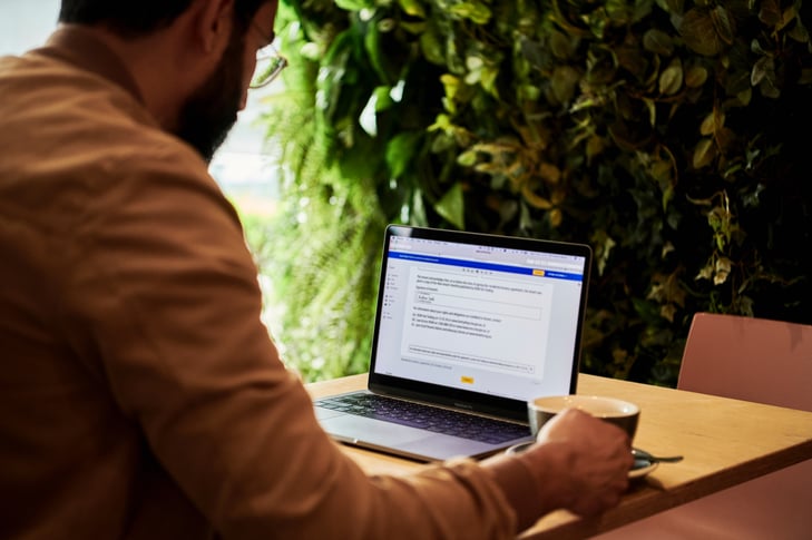 A man at a cafe working on his laptop