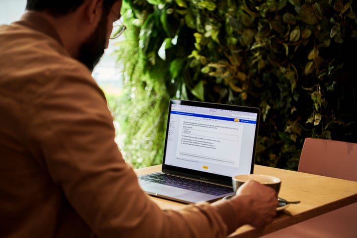 A man at a cafe working on his laptop