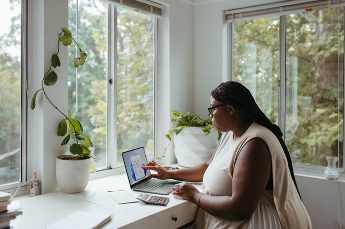 Person of color using a laptop