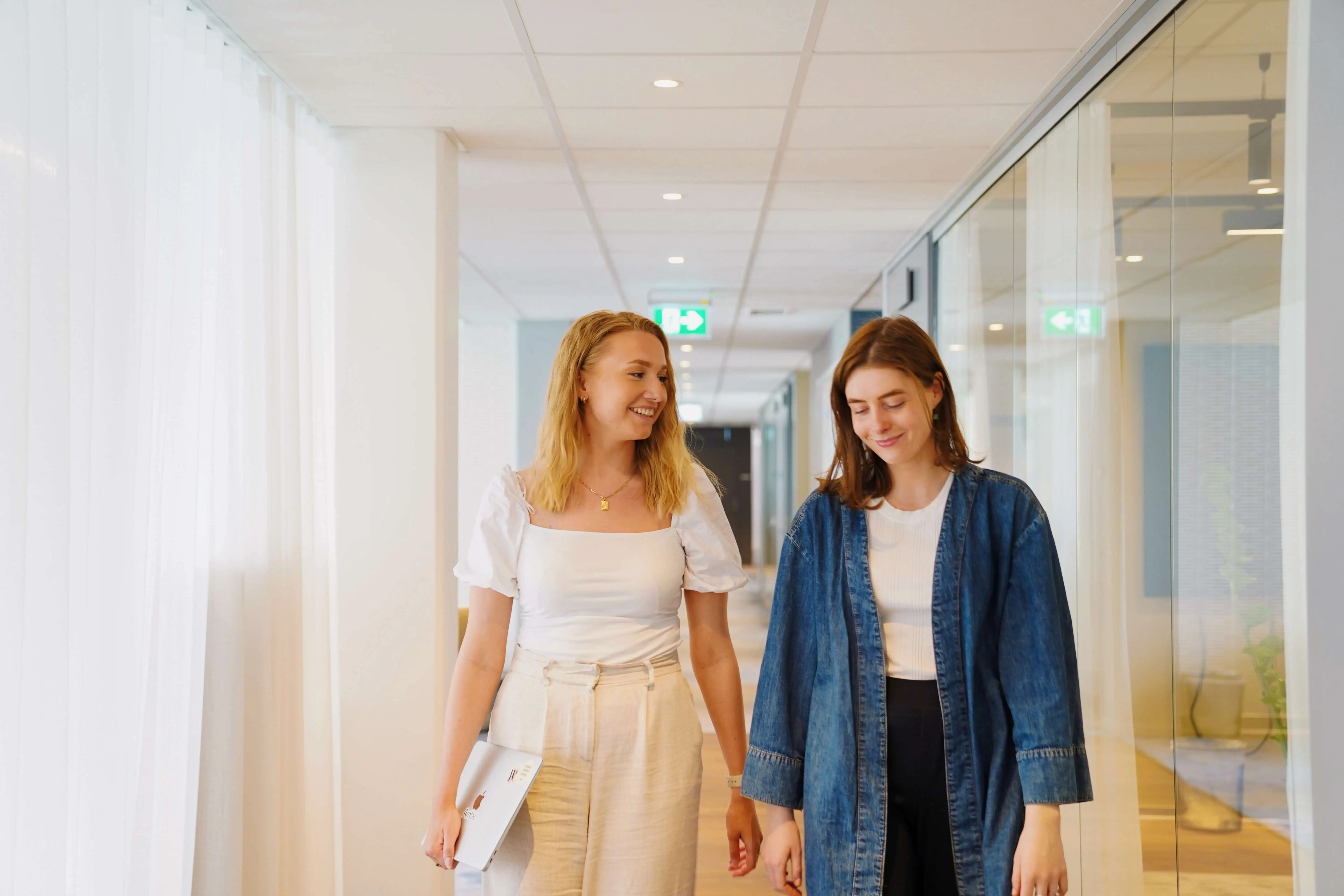 Two women walking in the hall