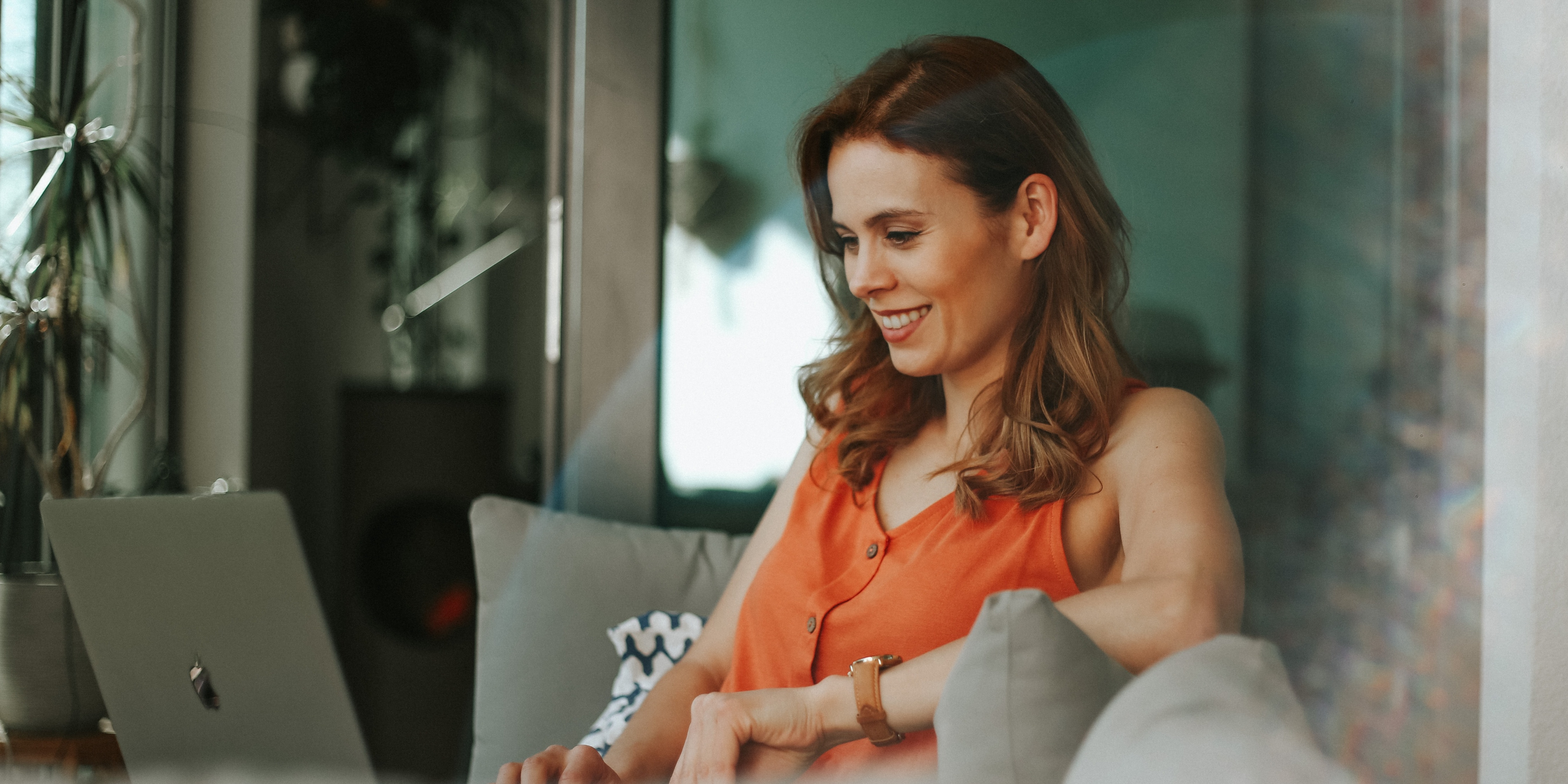 A woman on the couch looking into her laptop